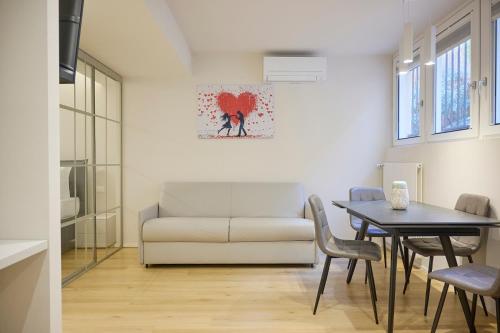 a living room with a couch and a table at Milan Retreats Fiera Milano City in Milan