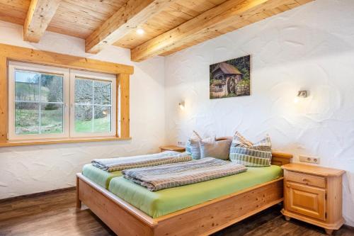 a bedroom with a bed and a window at Gästehaus zur alten Mühle in Vöhrenbach