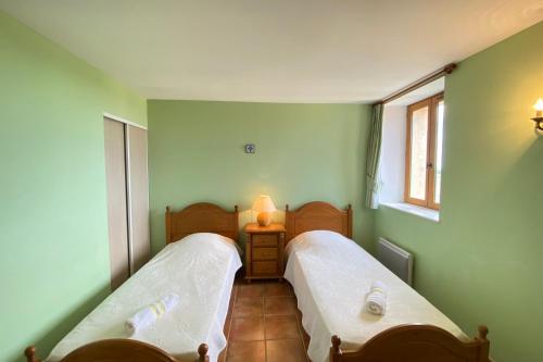 two beds in a room with green walls at 04B8 Beautiful T3 in the heart of lavender - pool in Brunet
