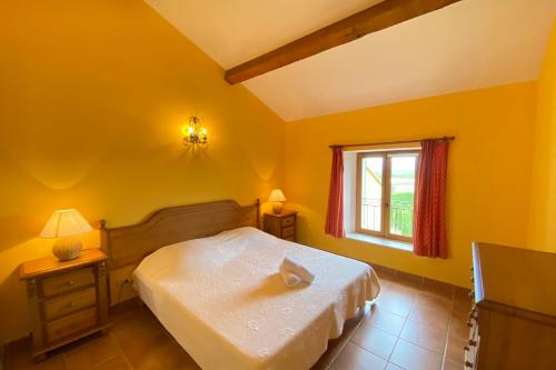a yellow bedroom with a bed and a window at 04B8 Beautiful T3 in the heart of lavender - pool in Brunet
