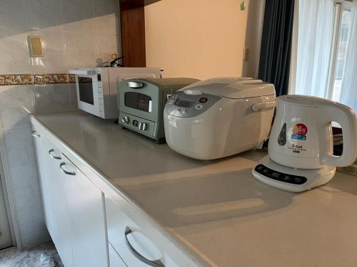 a kitchen counter with a mixer and a microwave at Sunrise terrace kintown in Kin