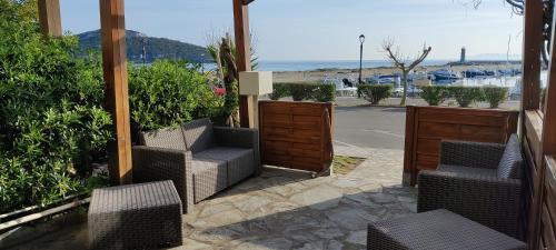 a patio with chairs and a view of the ocean at La marine in Rogliano