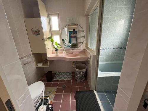 a small bathroom with a sink and a mirror at Sunrise terrace kintown in Kin