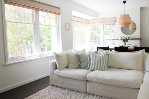 a white couch in a living room with windows at Casa thirty-six, 3BR, Central Location in Tanunda