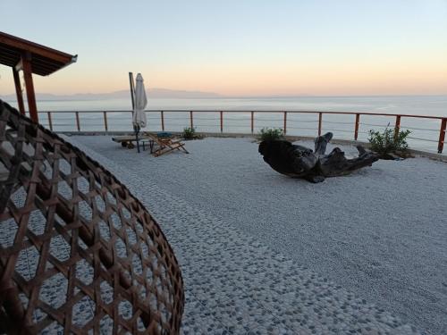 a fence on the beach with the ocean in the background at Gavdos Panorama in Gavdos