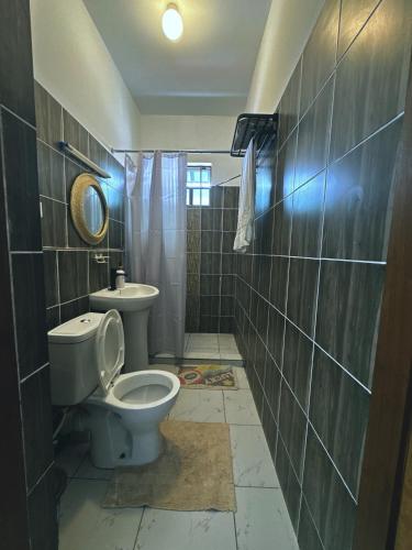 a bathroom with a toilet and a sink at Atieno home in Kwale