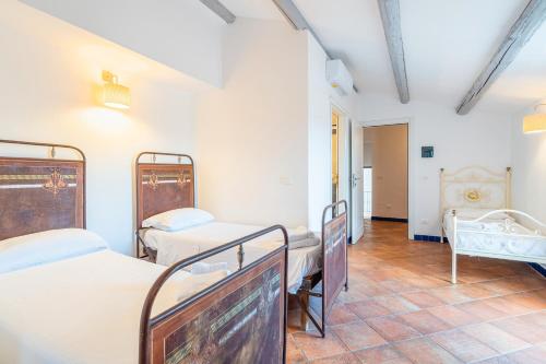 a hospital room with two beds and a tv at Al Palmento Relais in Siracusa