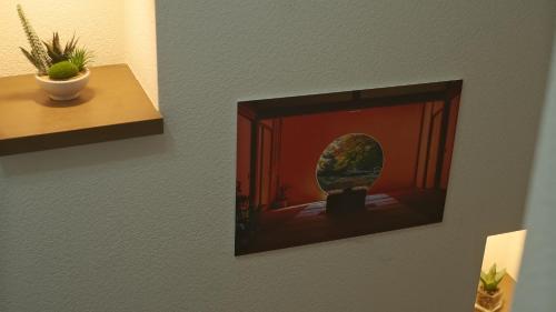 a picture hanging on a wall in a room at Villa Lotus in Kamakura