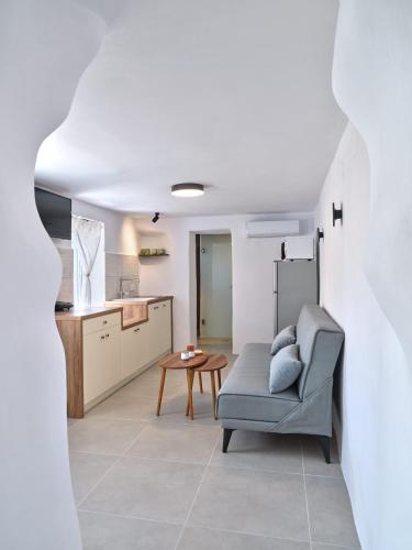 a living room with a couch and a table at Lefkes Blissful Home in Lefkes