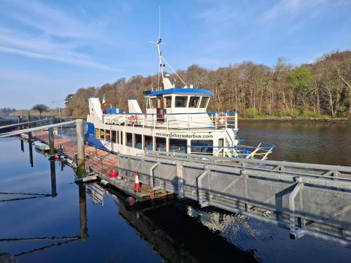 a boat is docked at a dock at Kates Place Studio 1 in Donegal