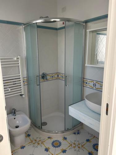 a bathroom with a shower and a toilet and a sink at Casa Nannina in Anacapri