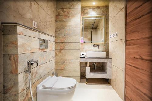 a bathroom with a toilet and a sink at Alivaa Hotel, McLeodganj With Best Dhauladhar View & Infinity Pool Sky Garden in McLeod Ganj