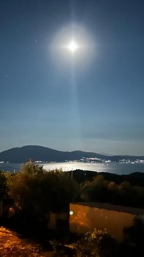 a view of a body of water with the sun in the sky at Cassiopea Guest House Evia Greece in Nerotriviá