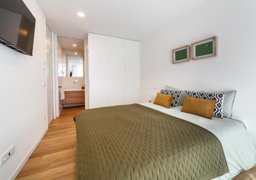 a bedroom with a large bed in a room at The Green Tiles Apartment incl Parking by Home Sweet Home Aveiro in Aveiro