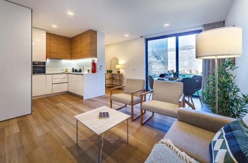 a living room with a couch and a table at The Green Tiles Apartment incl Parking by Home Sweet Home Aveiro in Aveiro