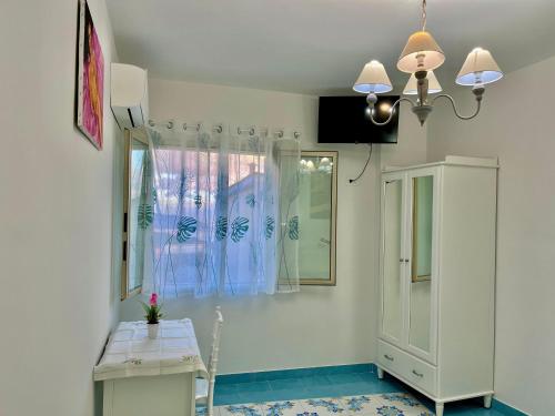 a room with a table and a mirror and a window at Il borgo di Iaconti in Vietri sul Mare