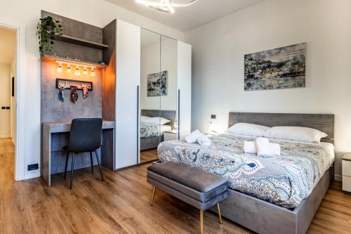 a bedroom with a bed and a desk and a chair at Silk & Sunset - City and Lake View with parking in Como