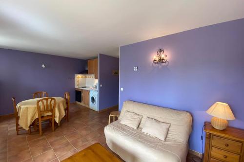 a living room with a couch and a table at 04B6 Beautiful studio in a mas provençal - pool in Brunet
