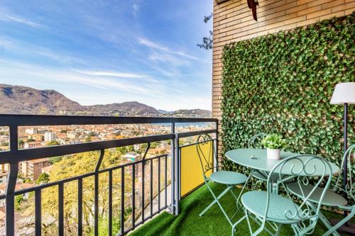 a patio with a table and chairs on a balcony at Silk & Sunset - City and Lake View with parking in Como