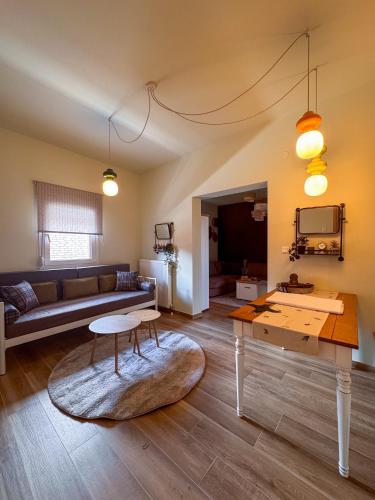 a living room with a couch and a table at Bebis House in Prosílion