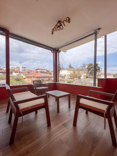 a room with benches and tables and a large window at Bebis House in Prosílion
