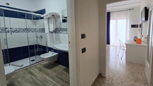 a bathroom with a shower and a sink and a toilet at Hotel Il Nido Sorrento in Sorrento