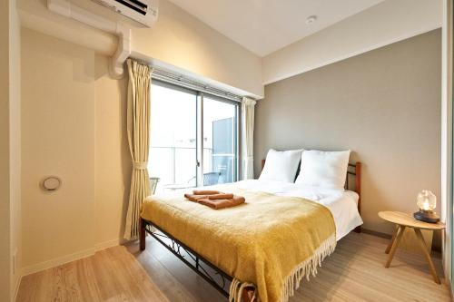 a bedroom with a bed with a large window at Nomadland Shinagawa Omori 1004 in Tokyo