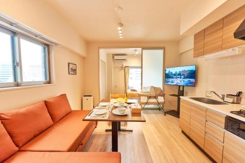 a living room with a couch and a table at Nomadland Shinagawa Omori 1004 in Tokyo