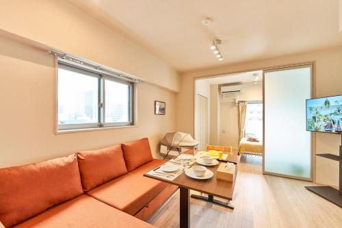a living room with a couch and a table at Nomadland Shinagawa Omori 1004 in Tokyo