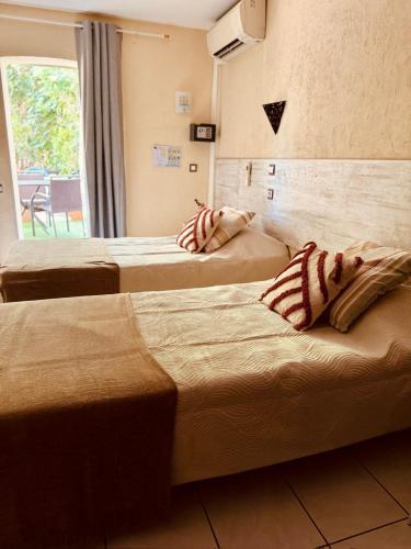 Ένα ή περισσότερα κρεβάτια σε δωμάτιο στο Hôtel le Nid
