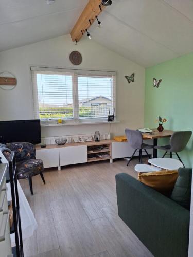 a living room with a couch and a table at Rekerlanden 267 in Warmenhuizen