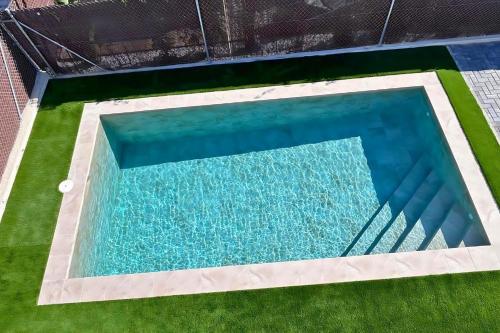 an overhead view of a swimming pool with grass at Golf sun and a private pool for a dream holiday! in Orihuela