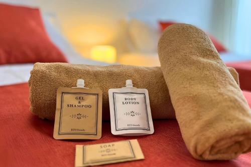 two complimentary complimentary towels and a pillow on a bed at Golf sun and a private pool for a dream holiday! in Orihuela