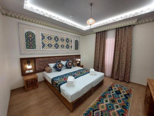 a bedroom with a large bed in a room at Zumrad Boutique Hotel in Bukhara