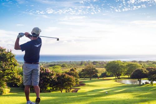 a man swinging a golf club on a golf course at Golf sun and a private pool for a dream holiday! in Orihuela
