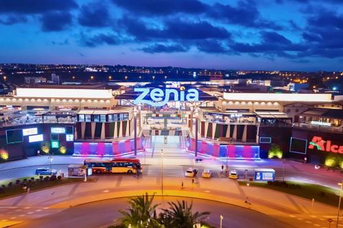 a city lit up at night with a bus at Golf sun and a private pool for a dream holiday! in Orihuela