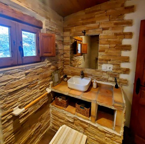 a bathroom with a sink and a wooden wall at Casa los chaparrales mirador in Los Anchos