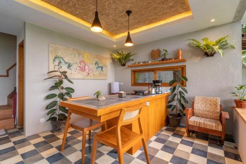 a kitchen with a wooden table and chairs at Villa Sare - House with panorama rice field view in Yogyakarta