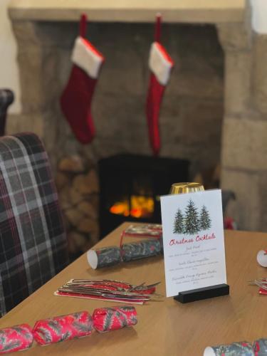 a table with christmas socks and a sign on it at The Cornhill Inn in Falkirk