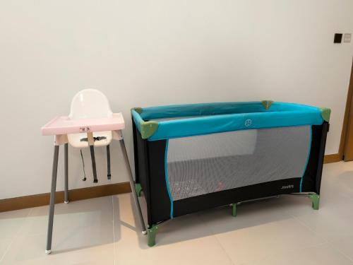 a ping pong table in a room with a pink stool at Vida Yacht Club # Up-scale 2BHK # Marina,Sea & Ain View in Dubai