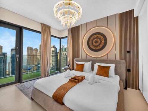 a bedroom with a large bed with a large window at Vida Yacht Club # Up-scale 2BHK # Marina,Sea & Ain View in Dubai