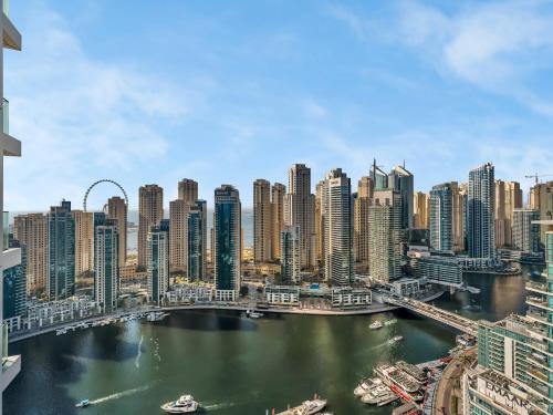 a view of a city with a river and buildings at Vida Yacht Club # Up-scale 2BHK # Marina,Sea & Ain View in Dubai