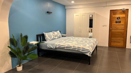 a bedroom with a bed and a blue wall at Think Koh Tao in Koh Tao