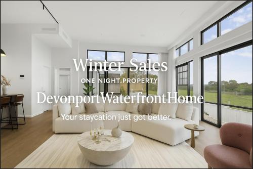 a white living room with a couch and a table at Devonport- Bayswater Luxury Home with BBQ in Auckland