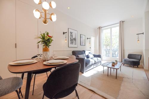 un salon avec une table et un canapé dans l'établissement Appartement luxe 2 chambres Grands Boulevards 4-6P, à Paris