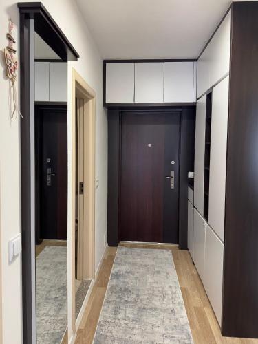 a hallway with two sets of doors in a building at Apartment in Kosovo Polje