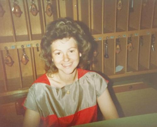 a young girl sitting in front of a rack of lockers at Greifensteiner Hof in Würzburg