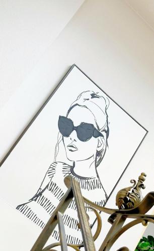 a drawing of a woman wearing sunglasses on a wall at Greifensteiner Hof in Würzburg