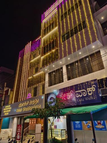 a tall building with lights on top of it at Hotel Shubhashree Comfort in Bijāpur