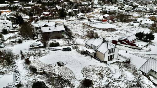 an aerial view of a snow covered city with houses at Apartment , Øygarden, Bergen in Torsteinsvik